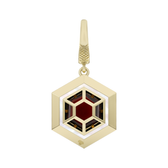 Gold hexagonal pendant with a red gemstone on a white background